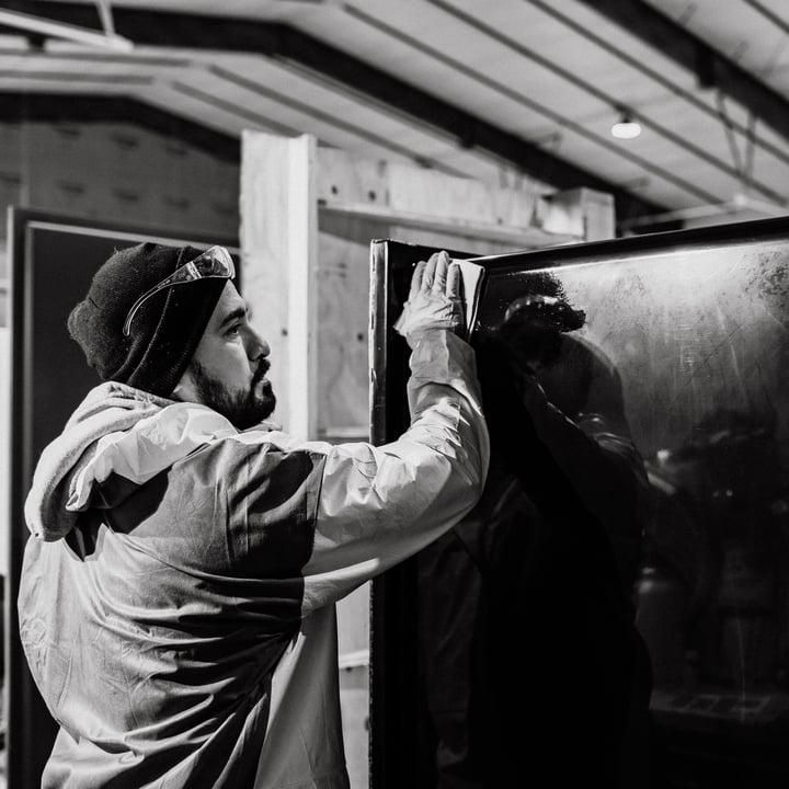 EverFab Bath employee sanding a pre-made fiberglass shower